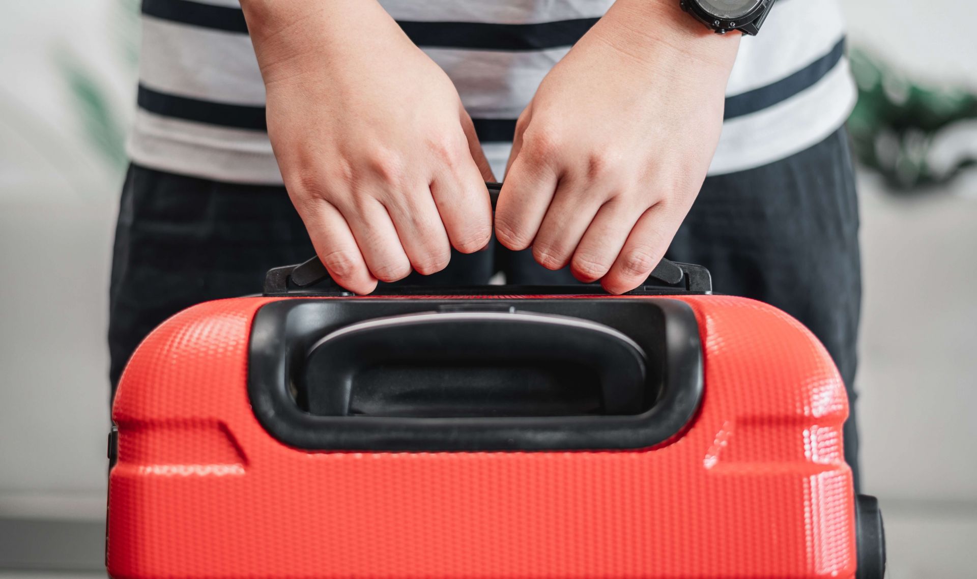 holding suitcase